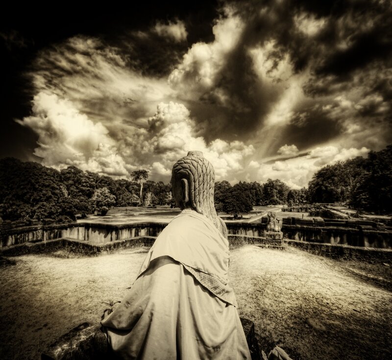 Buddha statue overlooking ancient ruins