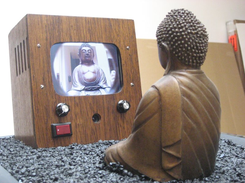Buddha statue watching TV
