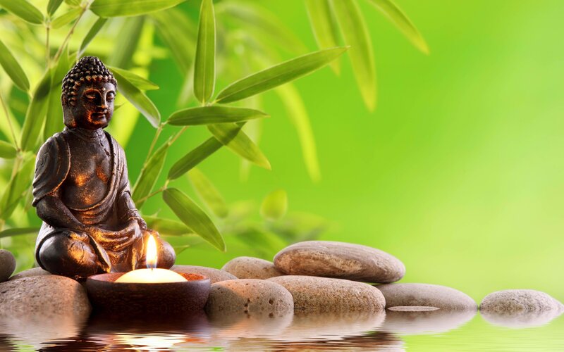 Buddha Statue with Candle — Green, Serene, Photograph, Rocks