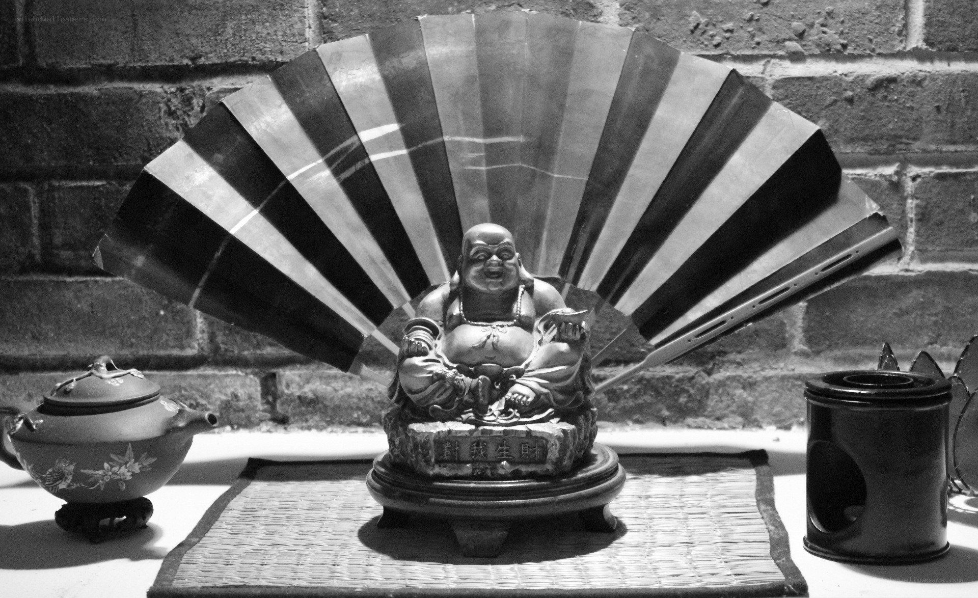 Buddha statue with fan and tea set