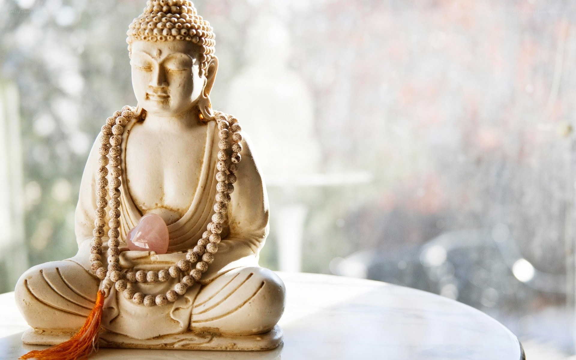 Buddha statue with mala beads