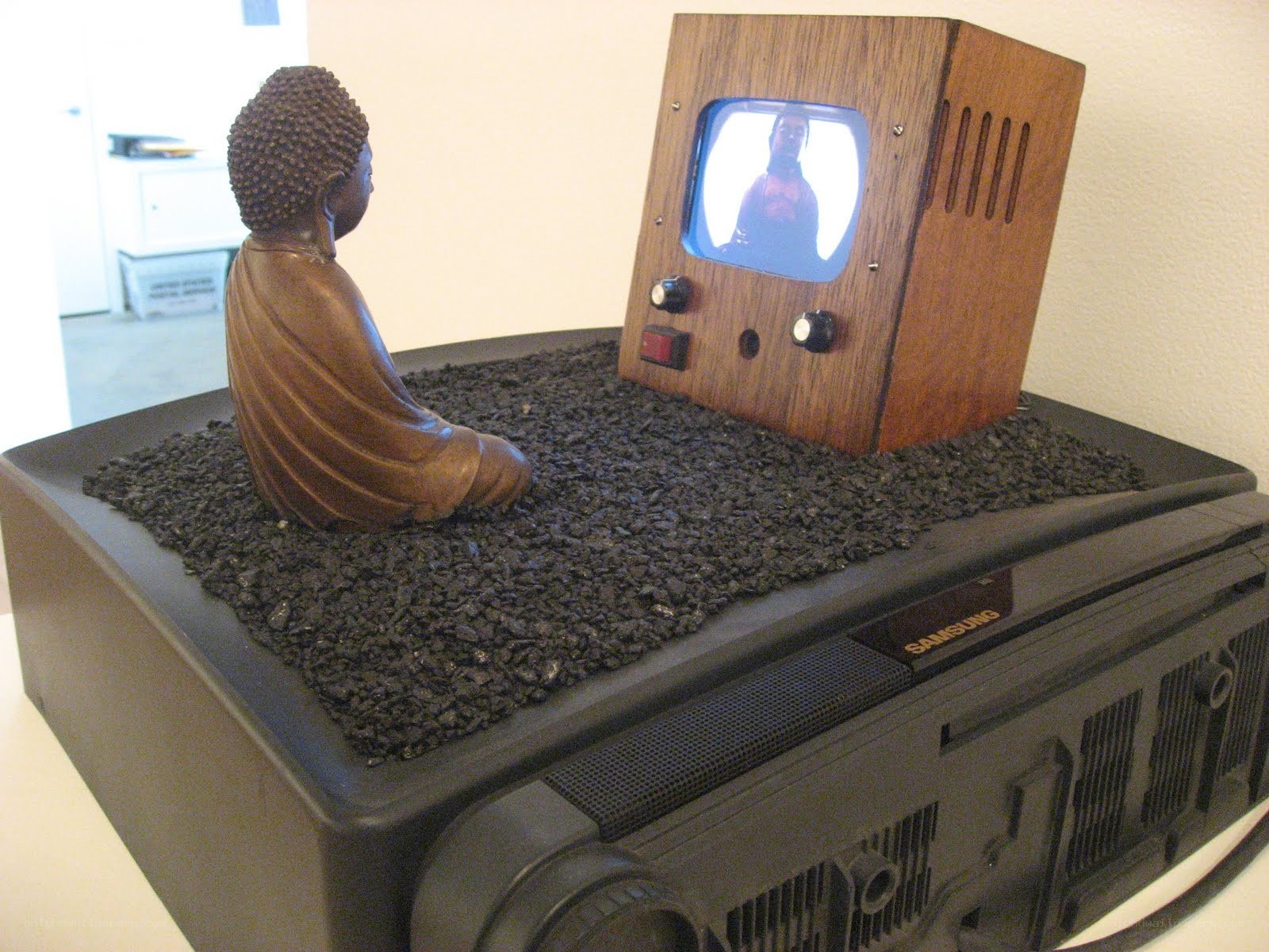 Buddha statue with vintage TV