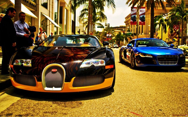 Bugatti and Audi sports cars on street