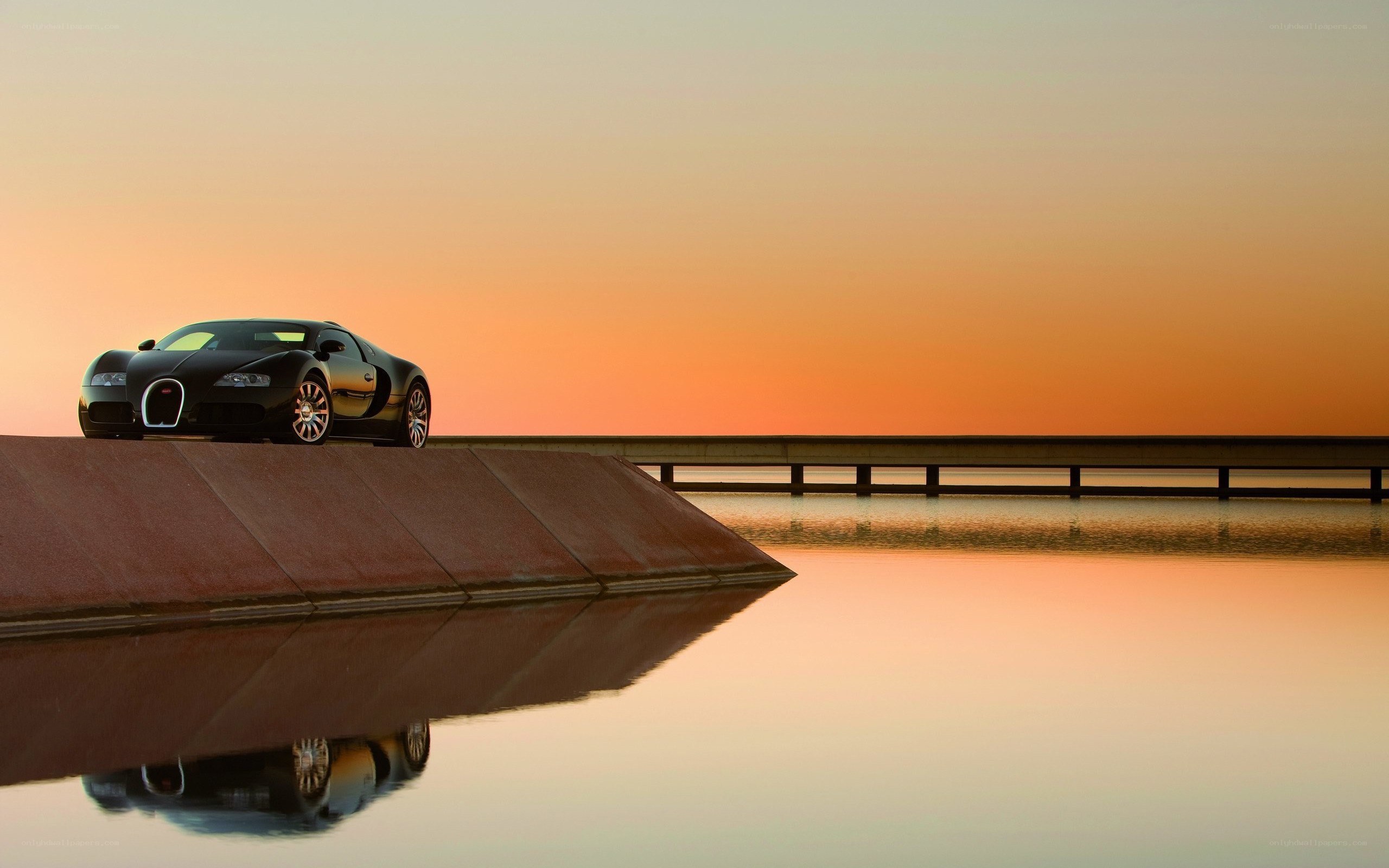 Bugatti on a pier at sunset