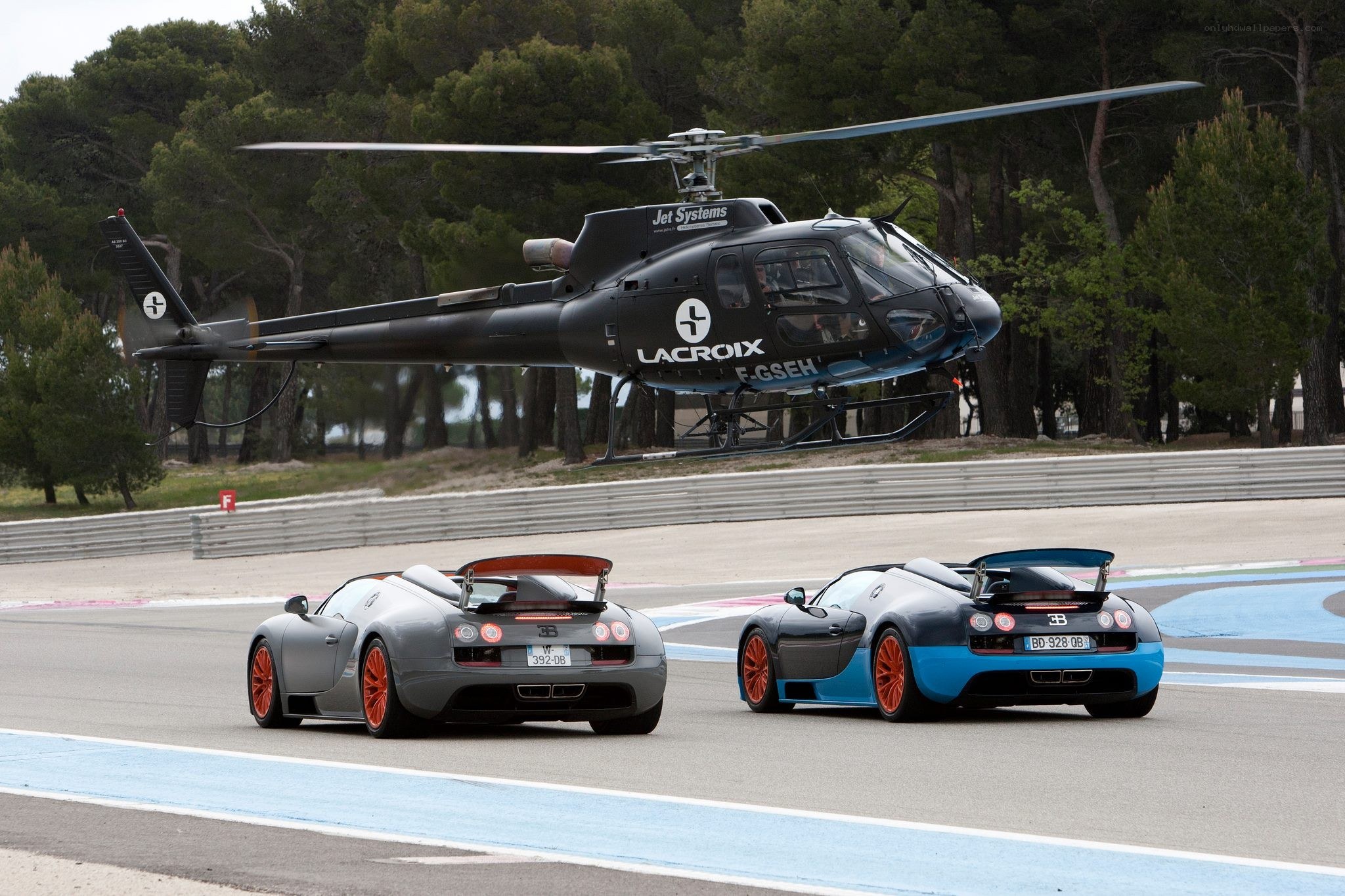 Bugatti Veyron and helicopter on track