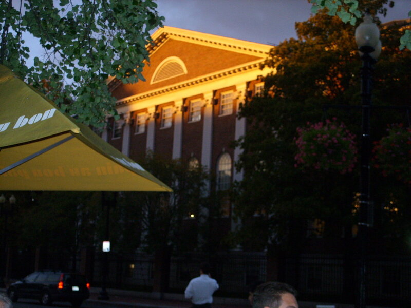 building at dusk with yellow umbrella