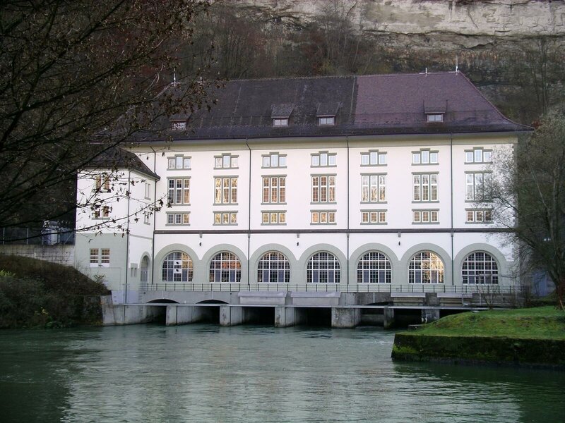 building by a river with arched windows
