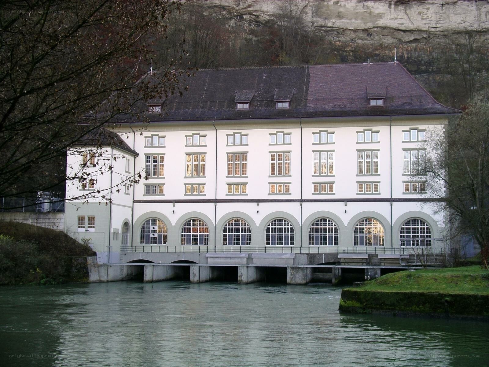 building by a river with arched windows