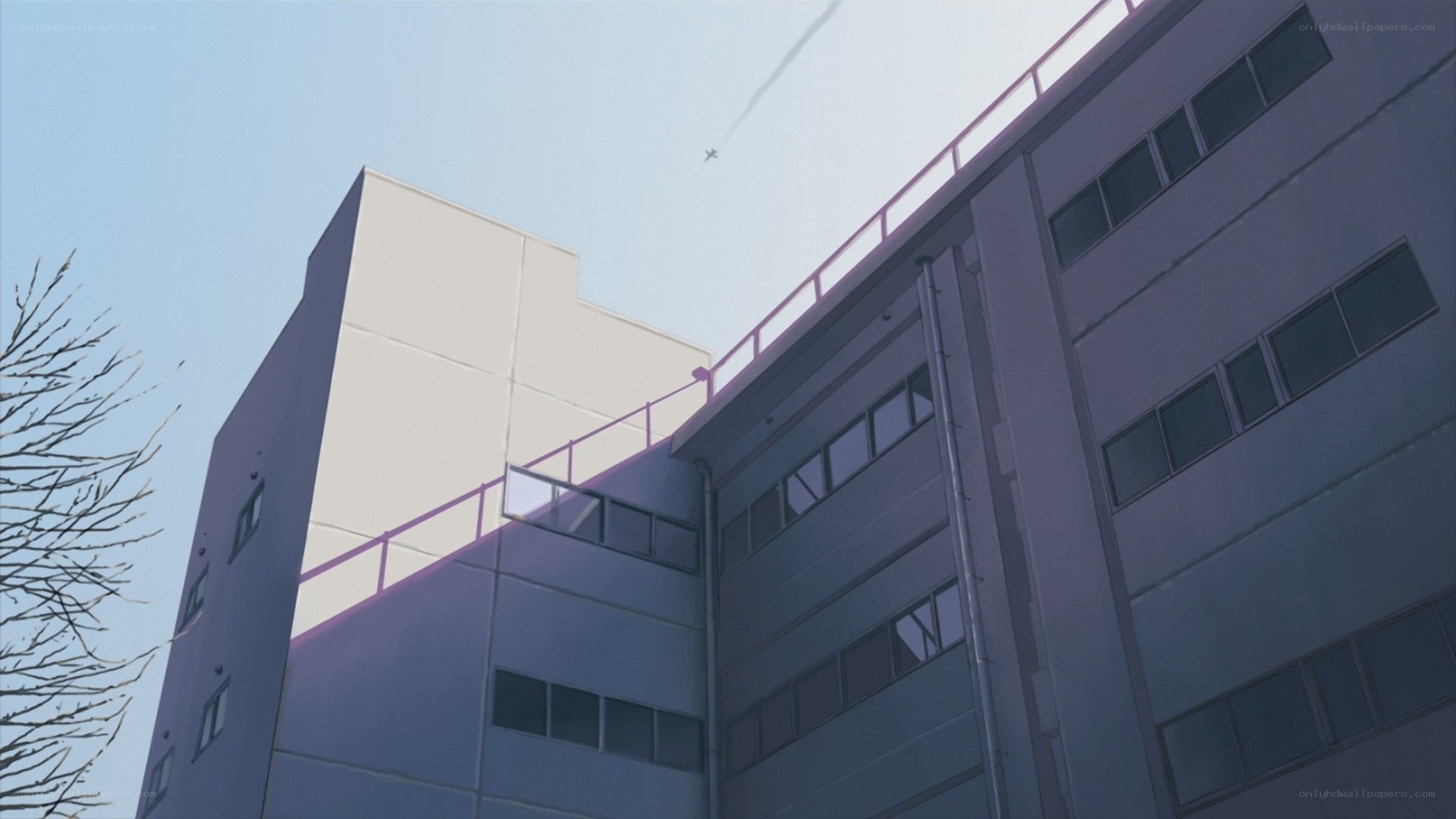 building with airplane in sky