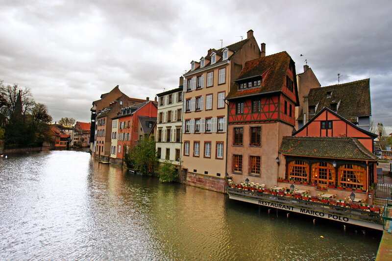 Buildings Along a River — Brown