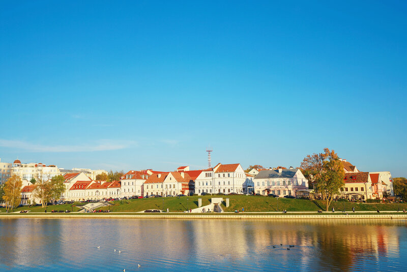 Buildings Along Riverbank — Blue, Serene, Afternoon, Photograph