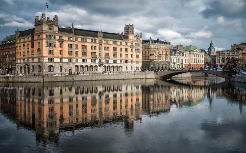 Buildings Along Riverbank — Gray, Dramatic, Winter