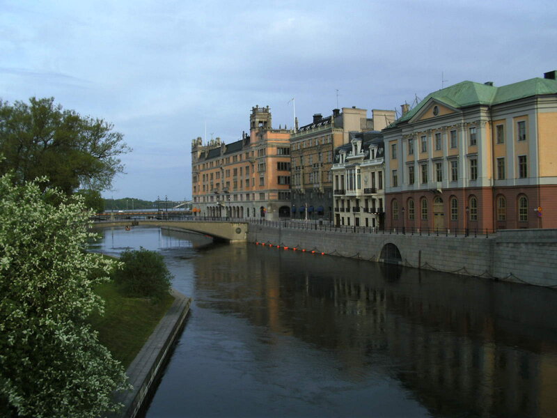 Buildings Along Riverbank — Gray