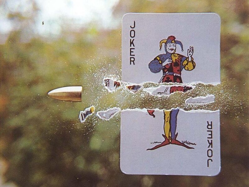 Bullet hitting joker card