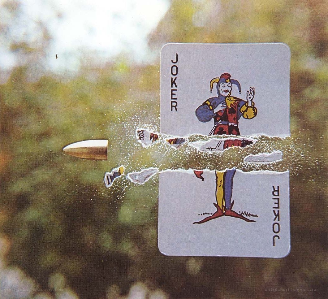 Bullet hitting joker card