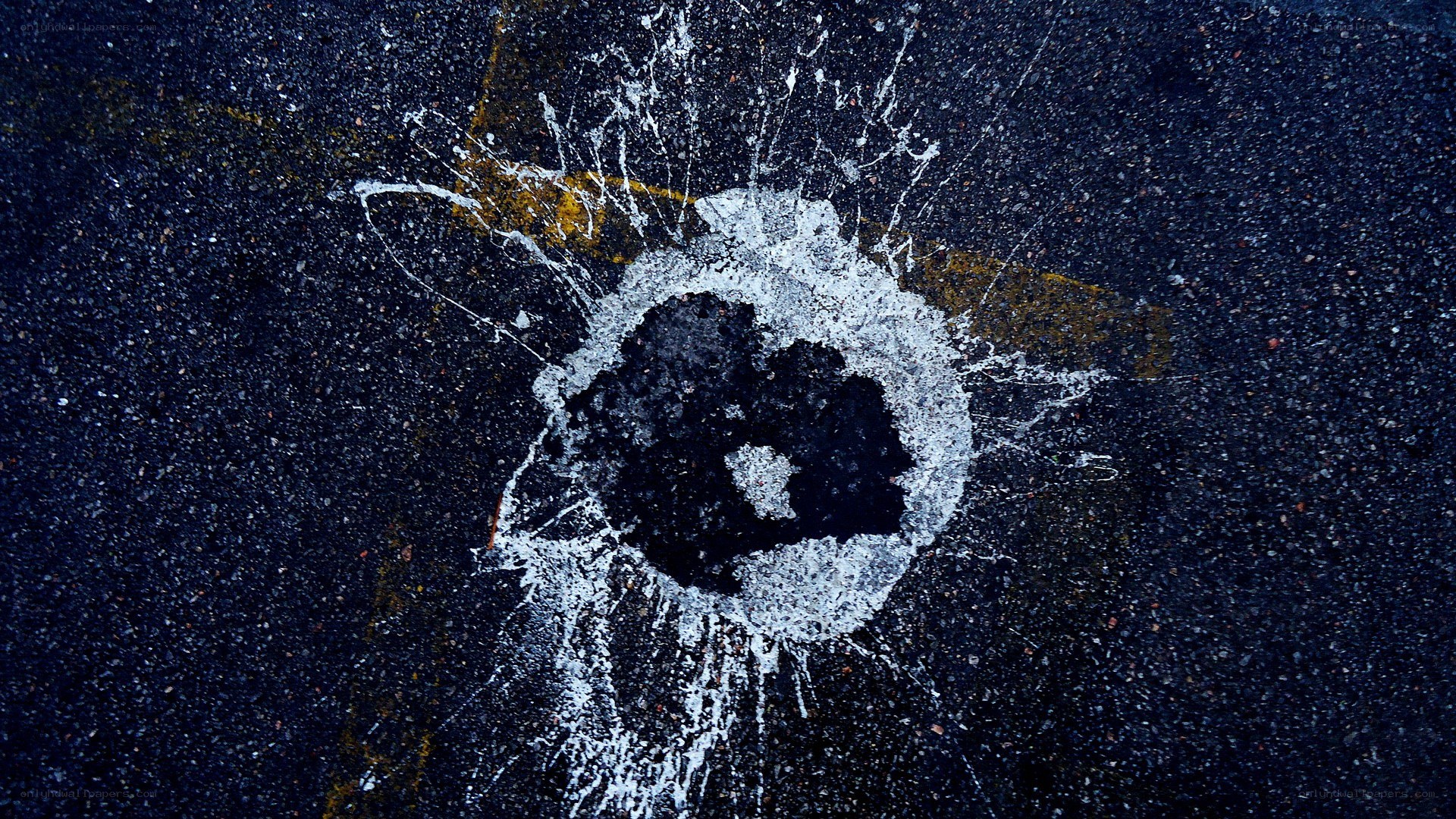 Bullet hole in asphalt