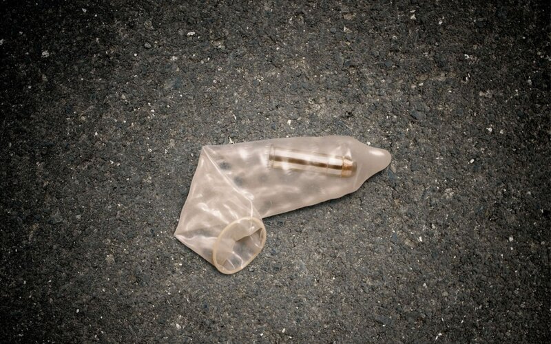 Bullet in a condom on pavement