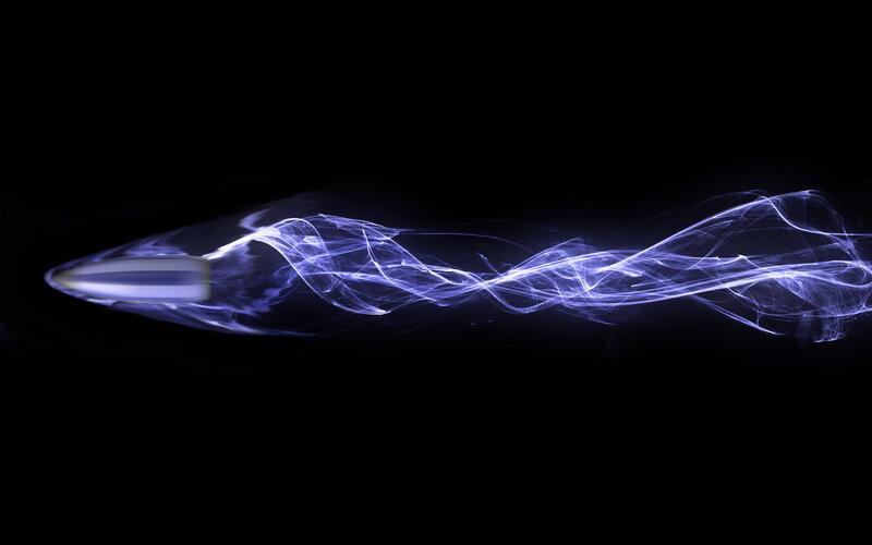 Bullet in motion with light trail