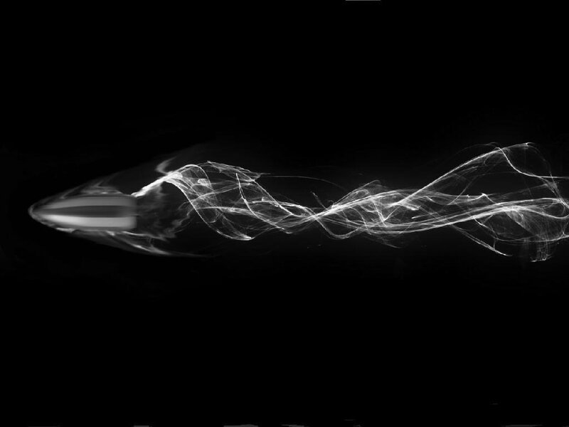Bullet in motion with smoke trail