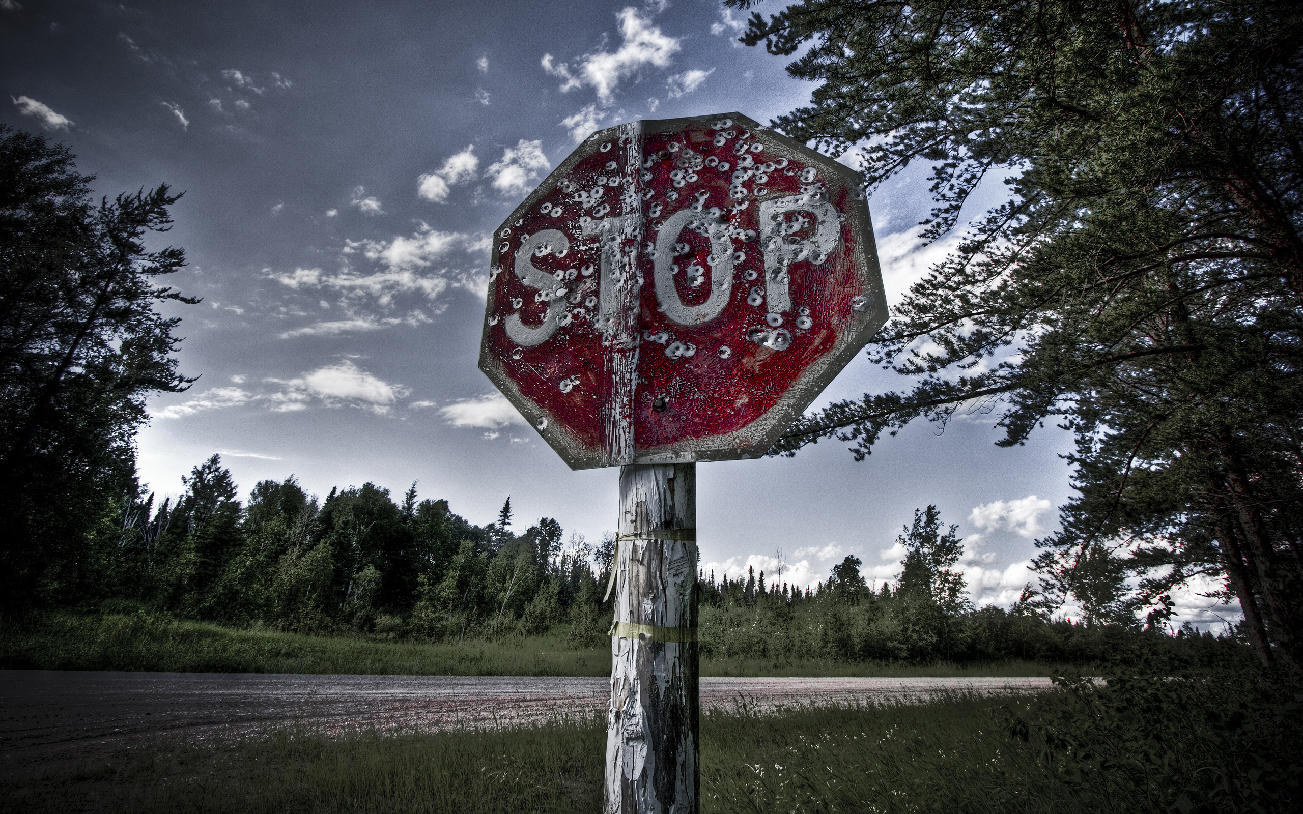 Bullet-riddled stop sign
