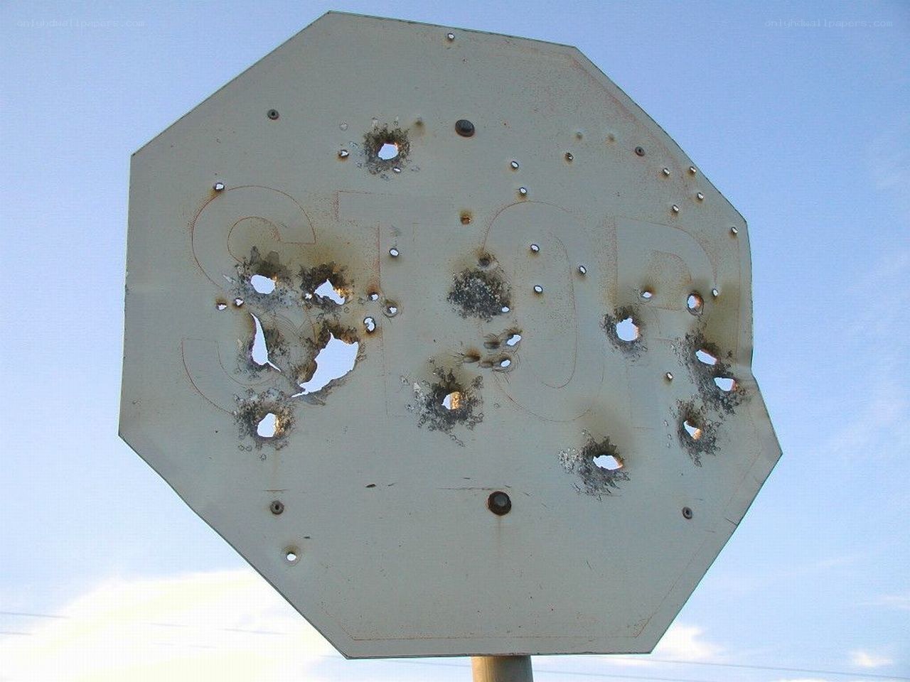 Bullet-riddled stop sign