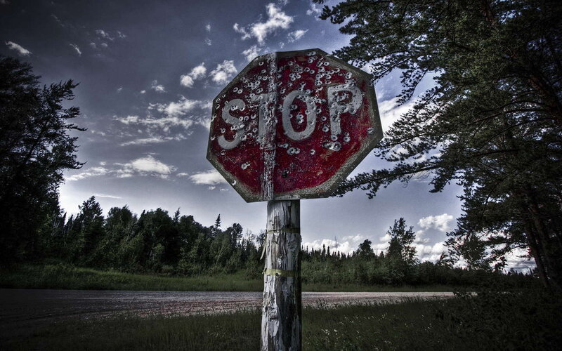 Bullet-riddled stop sign