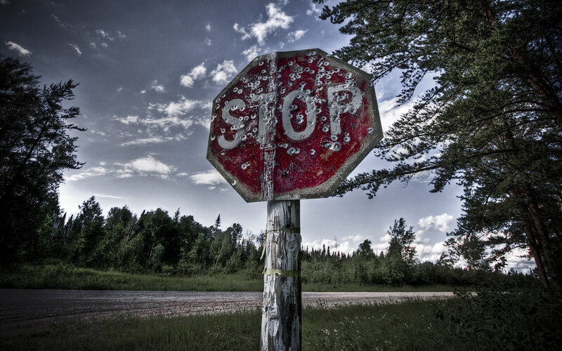 Bullet-riddled Stop Sign — Dramatic