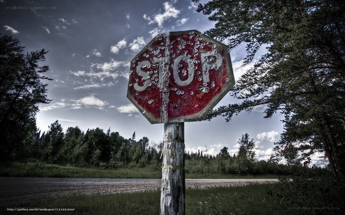 Bullet-riddled stop sign