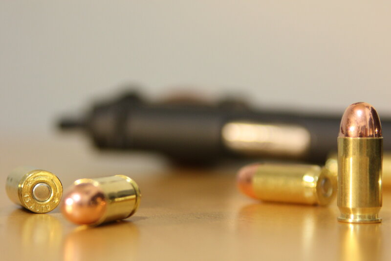 Bullets and handgun on table