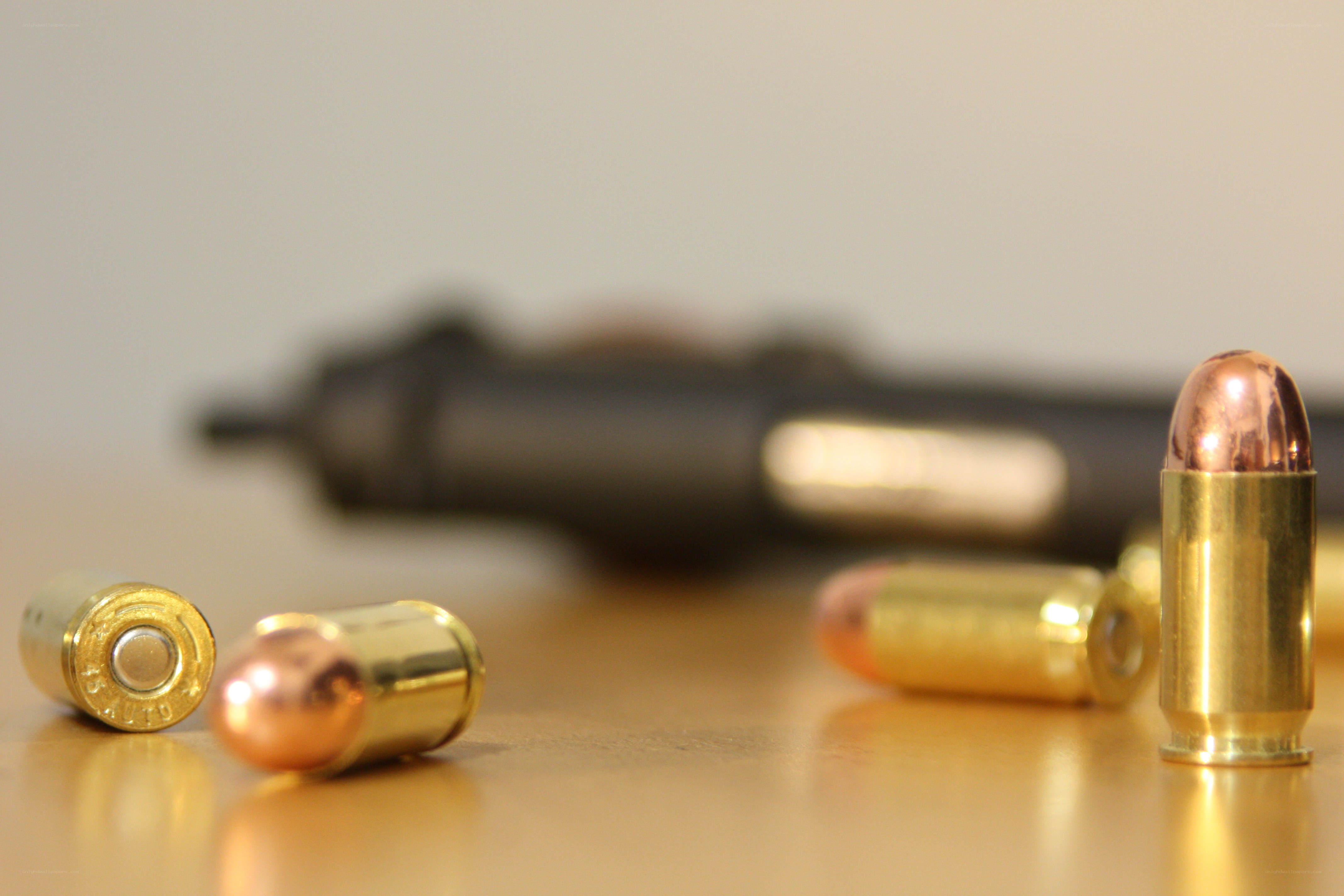 Bullets and handgun on table