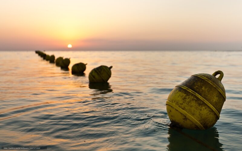 Buoys at sunset on calm water