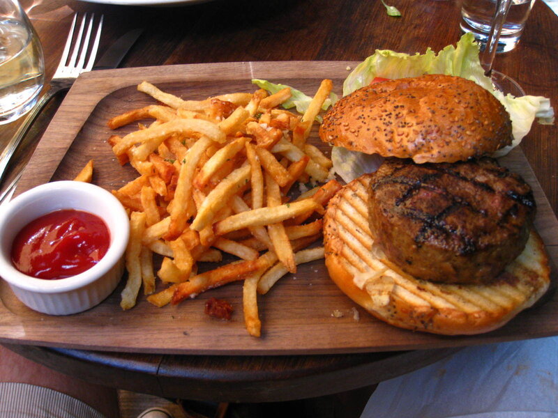 Burger and fries on a wooden board