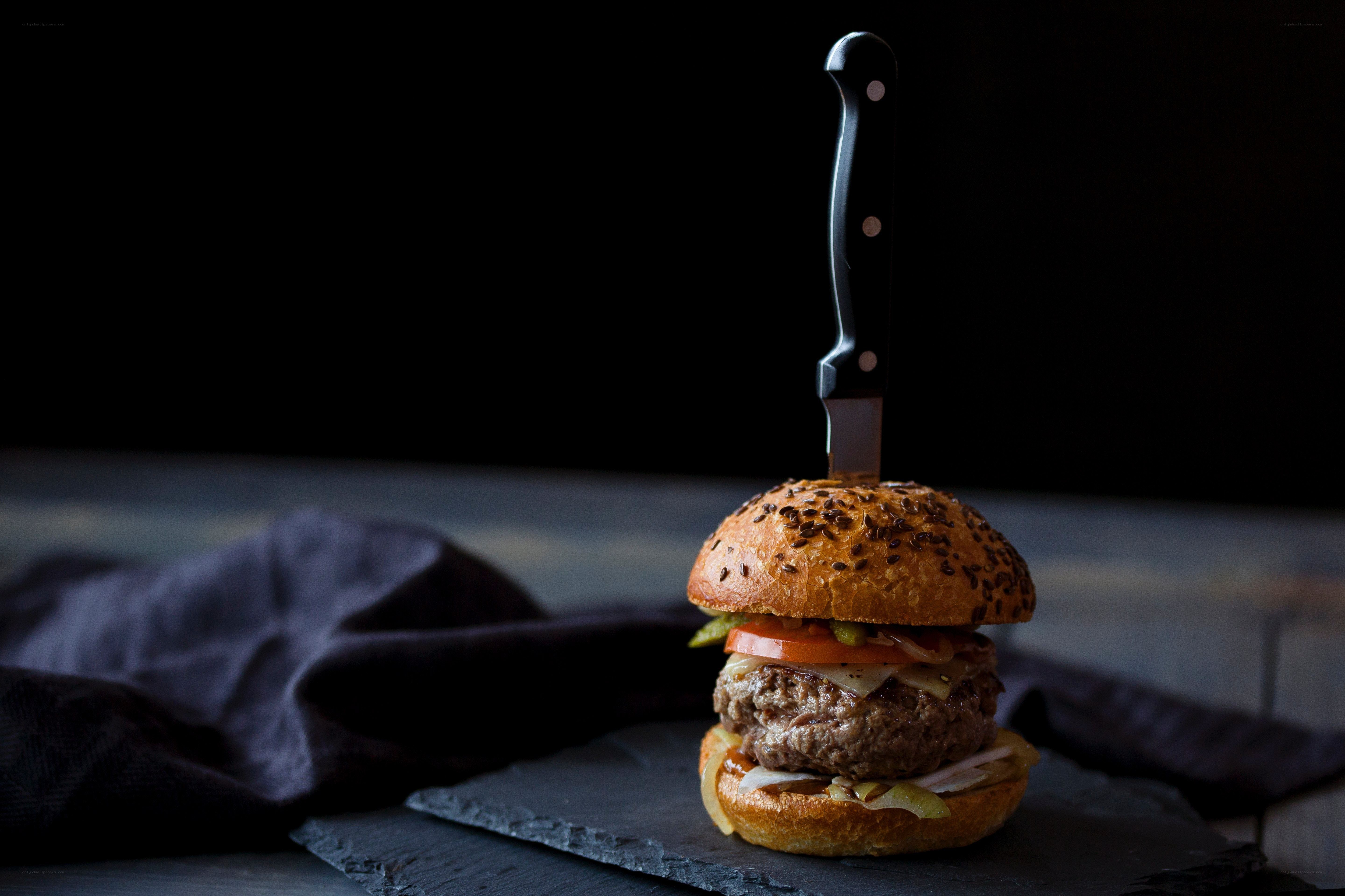 Burger with knife on top