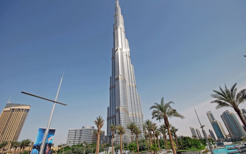 Burj Khalifa Skyscraper — Blue, Serene, Afternoon, Photograph, Palm Trees, Buildings