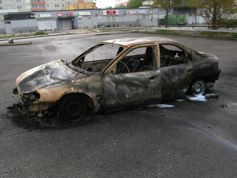 Burned Car in Parking Lot