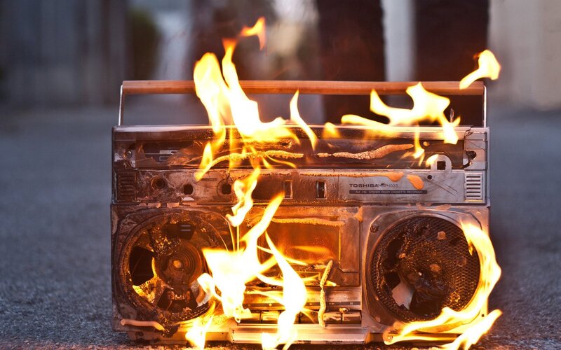 Burning boombox on pavement
