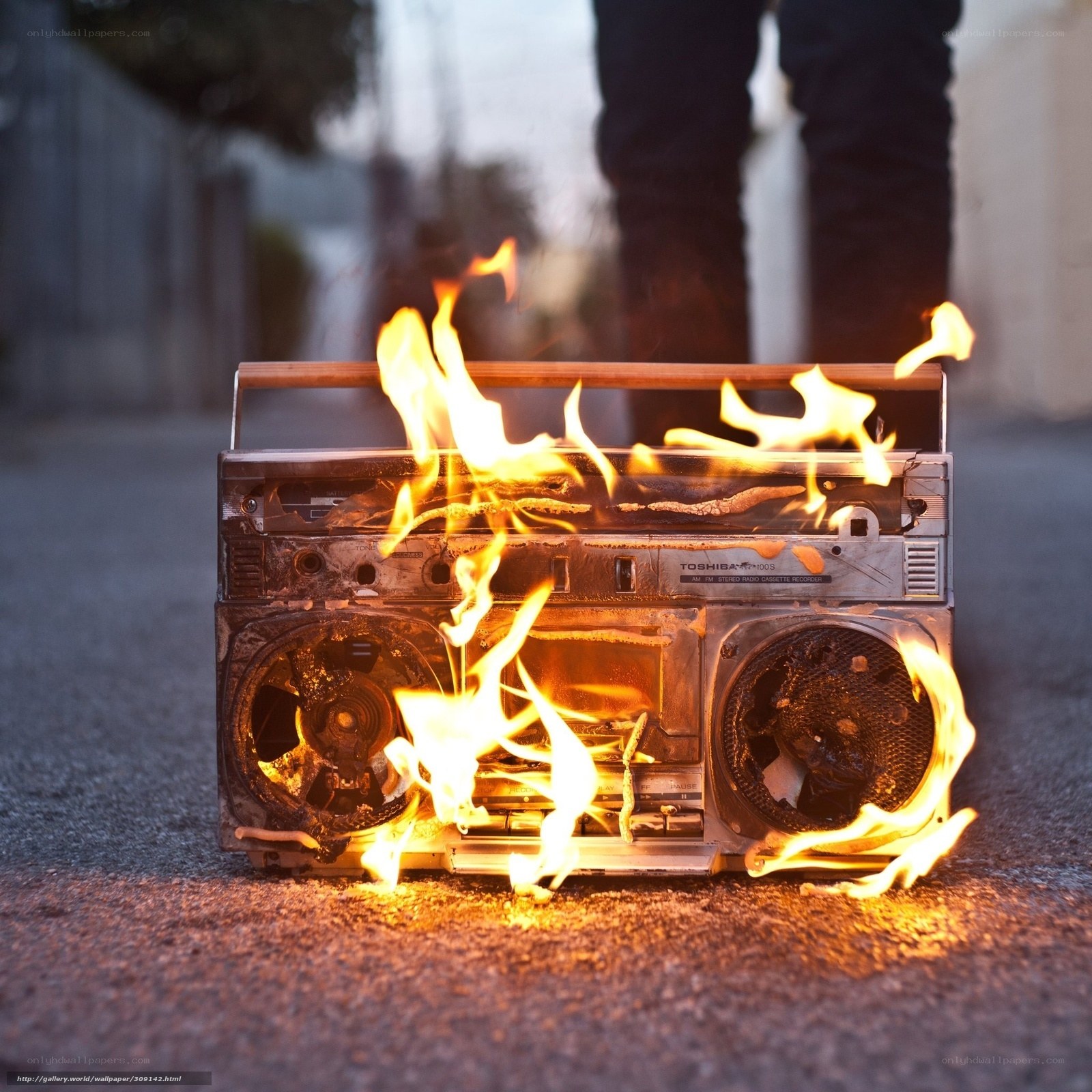 Burning boombox on pavement