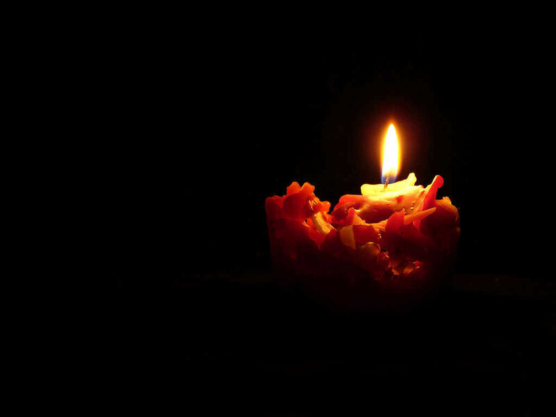 Burning Candle in Darkness