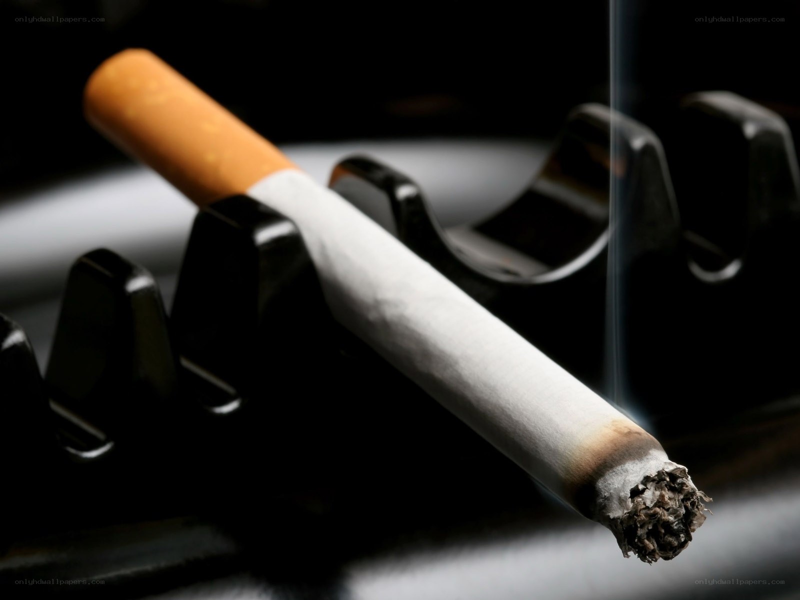 burning cigarette in ashtray