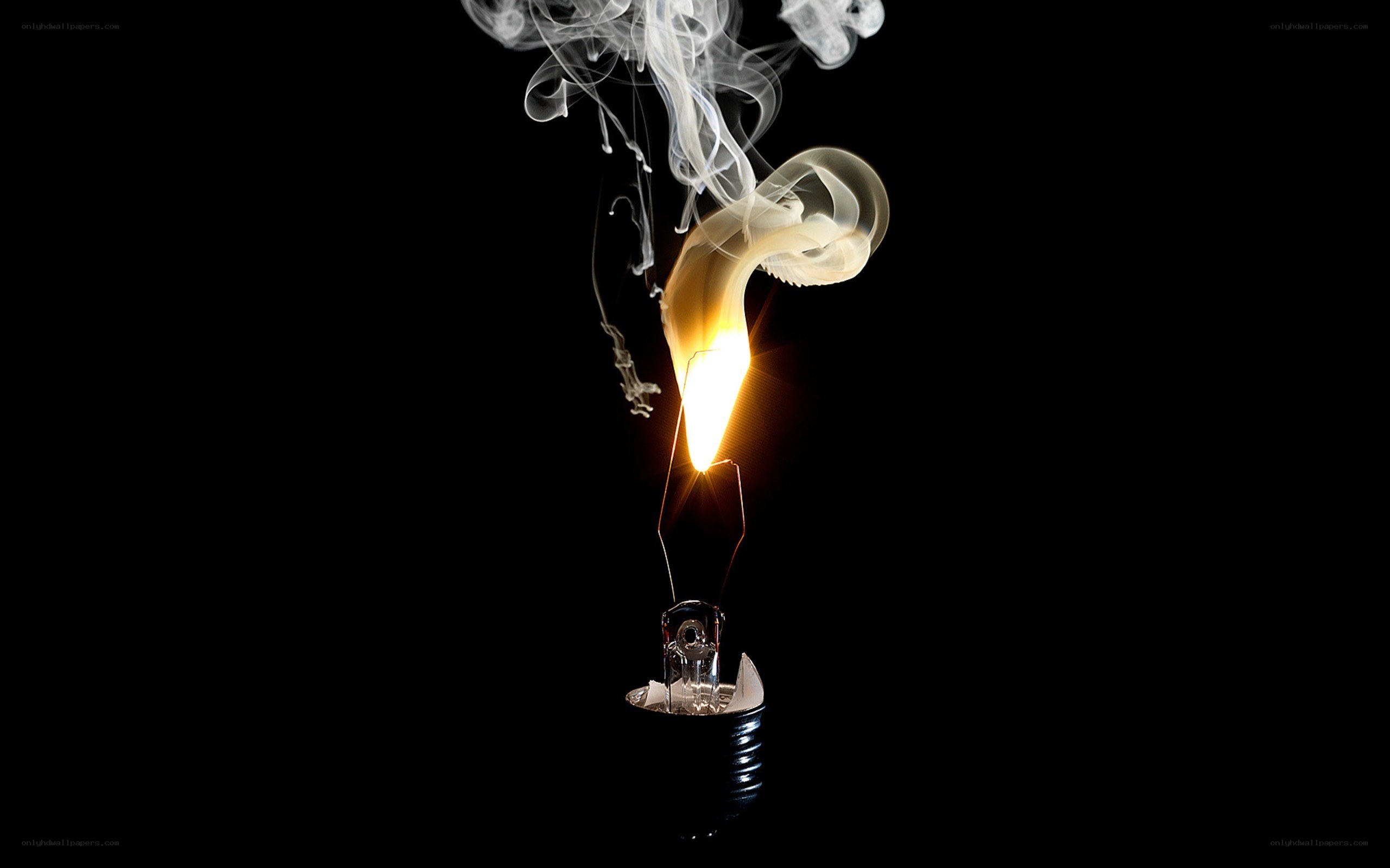 Burning light bulb with smoke