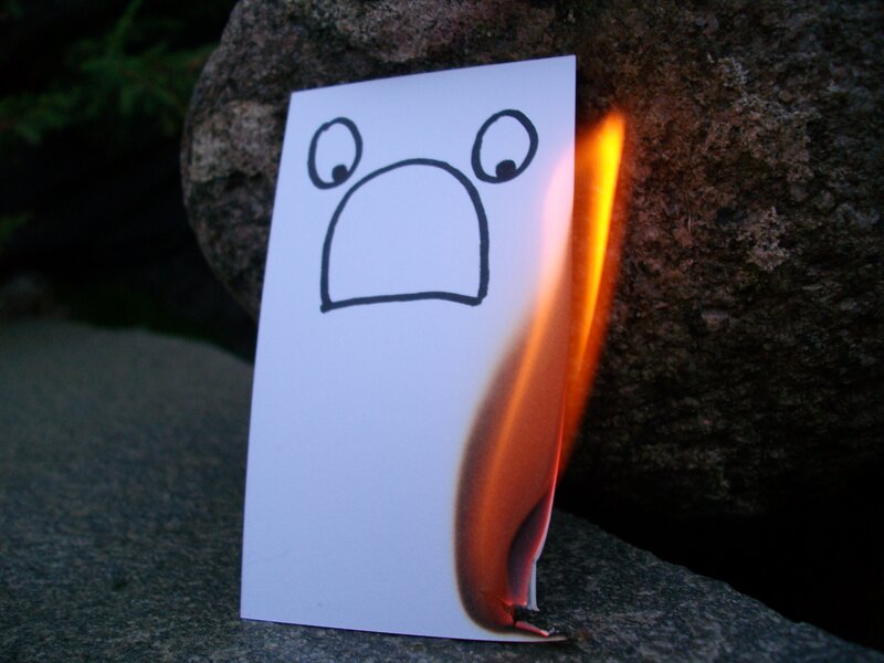 Burning paper with face drawing