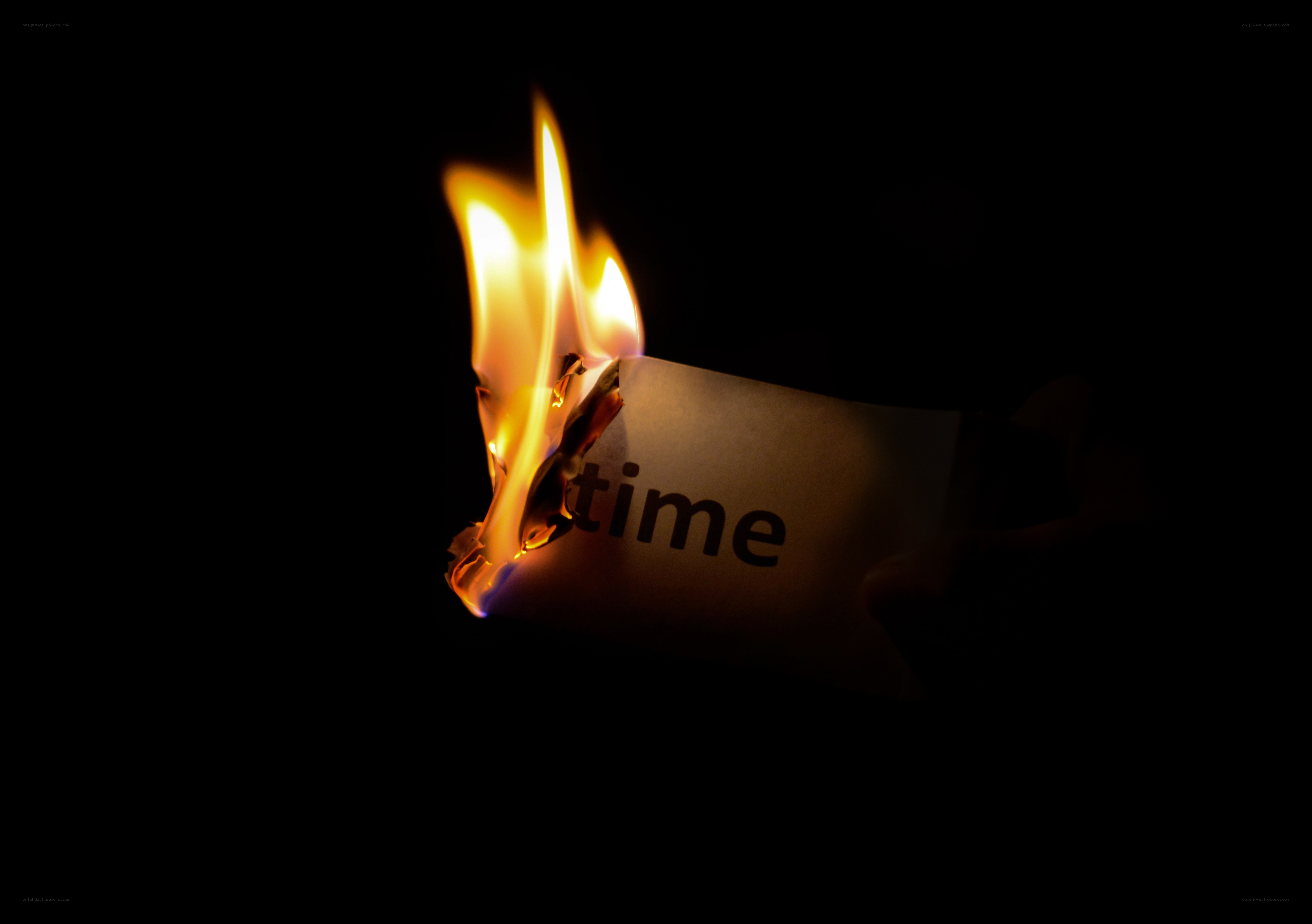 Burning paper with the word time