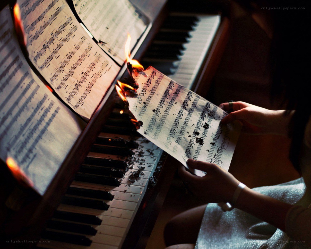 Burning sheet music on piano