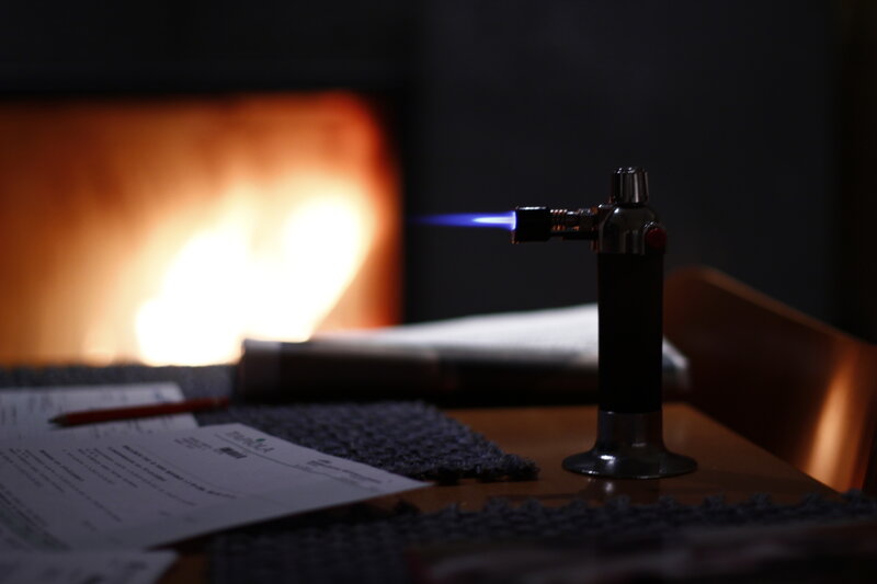 Burning torch by fireplace