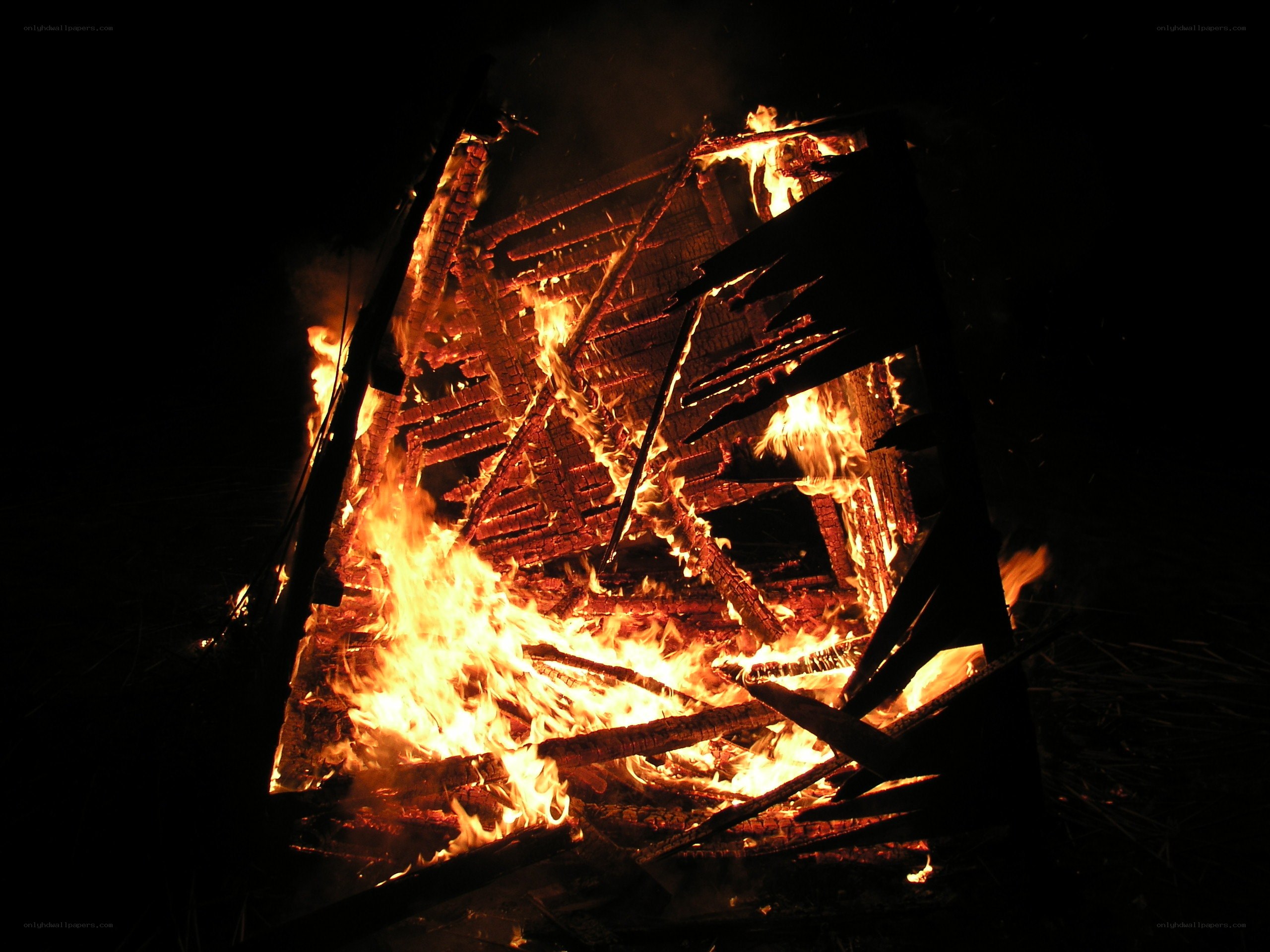 Burning wooden structure at night
