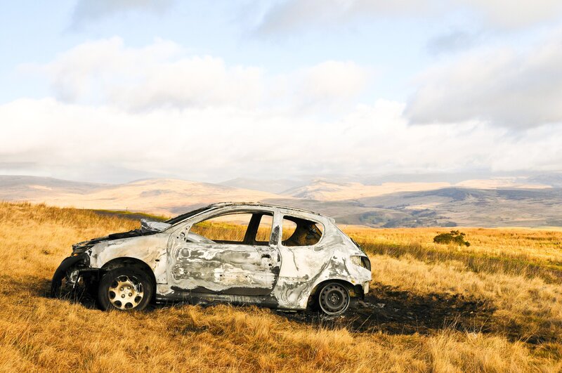 Burnt Car in Field — Brown