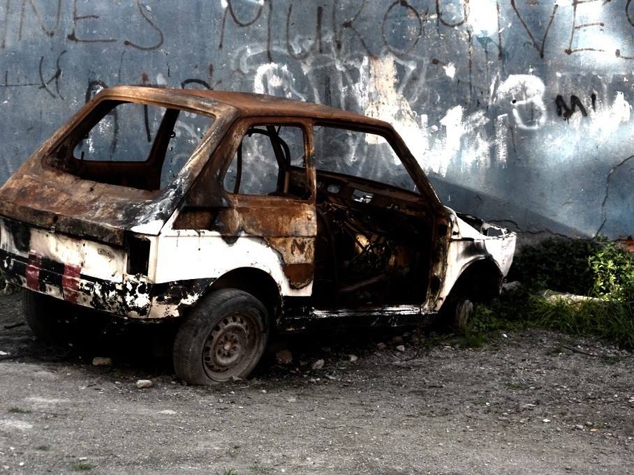 Burnt car in urban setting