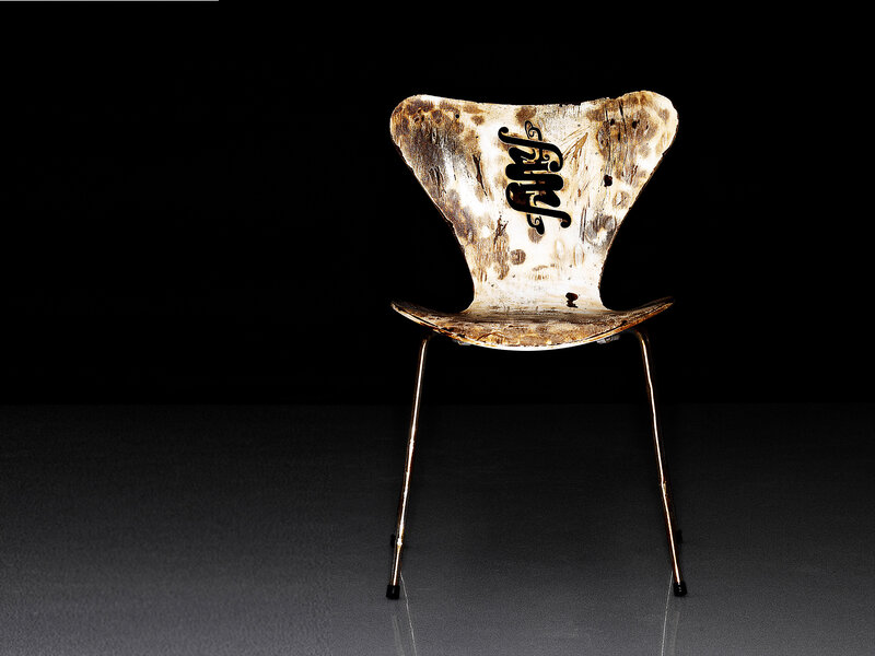 Burnt chair with signature
