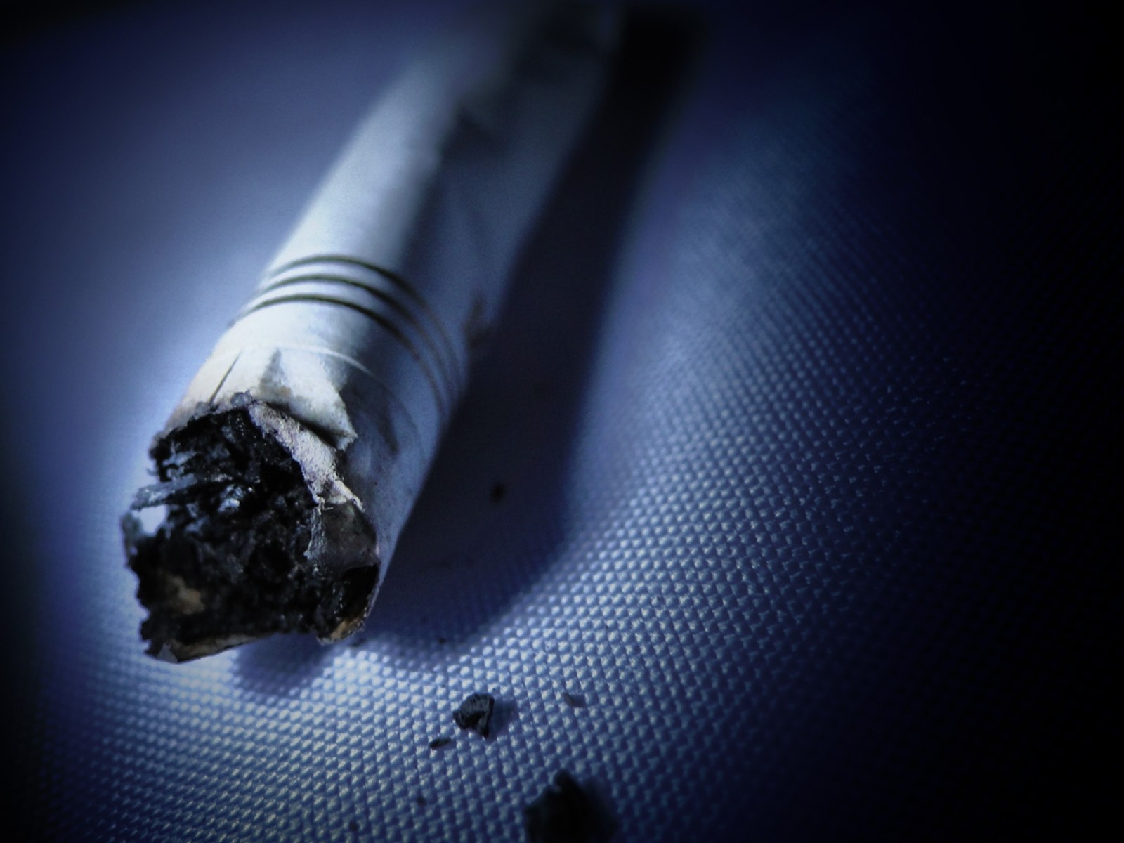 burnt cigarette on textured surface