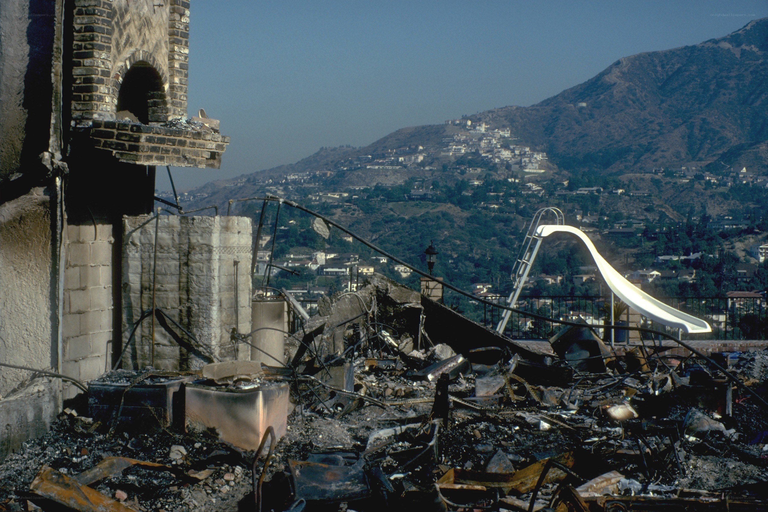 Burnt house with slide in background